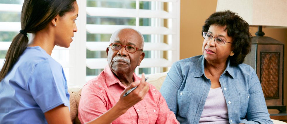 elderly couple having conversation with the caregiver